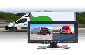 A vehicle camera monitor showing two red trucks on a highway.